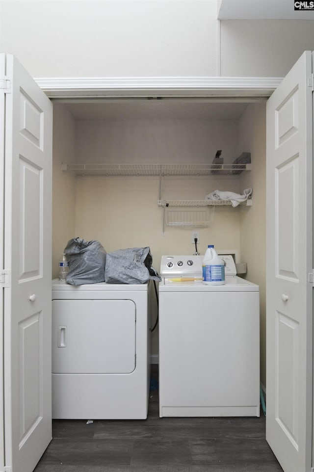 clothes washing area with laundry area, dark wood finished floors, and washing machine and dryer