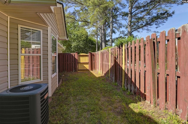 view of yard featuring central air condition unit and a fenced backyard