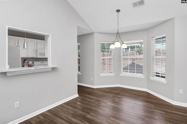 unfurnished dining area with visible vents, baseboards, dark wood-style floors, and vaulted ceiling