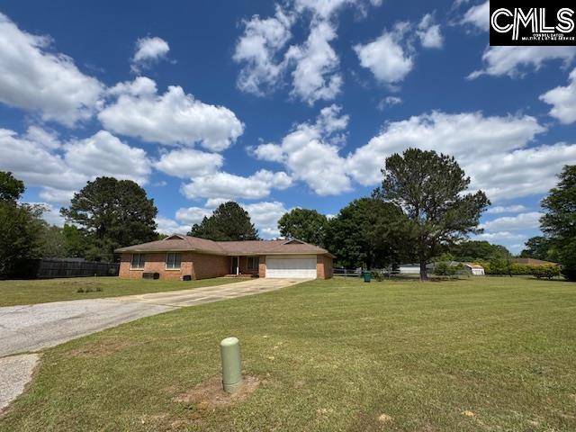 ranch-style house featuring a garage, a front lawn, and concrete driveway