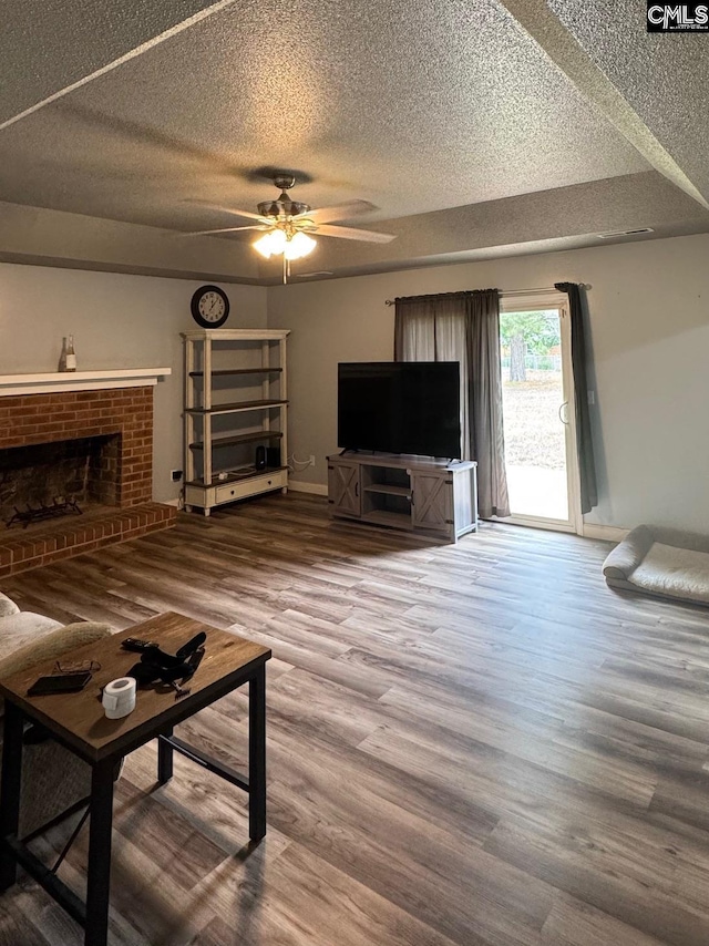 40 Turn Row Ct, Sumter, SC 29154 - unfurnished living room with a textured ceiling, ceiling fan, wood finished floors, baseboards, and a fireplace