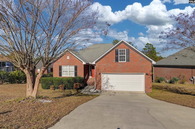 traditional home with brick siding, a garage, driveway, and a front yard