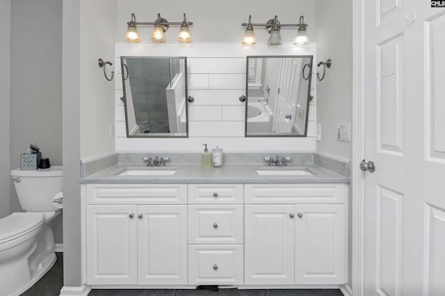 full bathroom featuring double vanity, toilet, a tub, and a sink