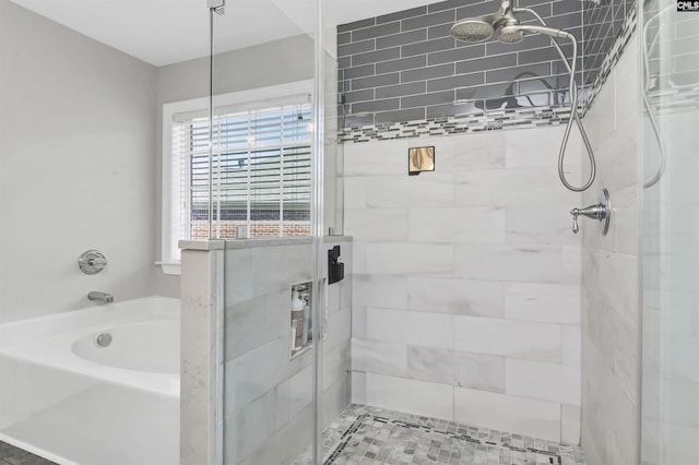 bathroom with a bath and a stall shower