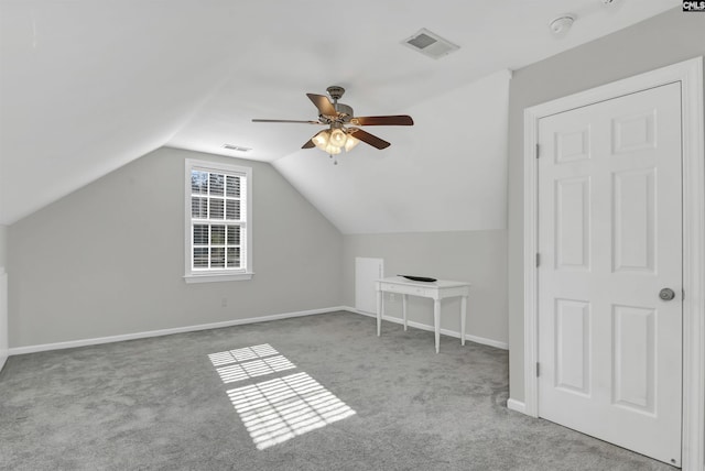 additional living space with carpet flooring, a ceiling fan, baseboards, lofted ceiling, and visible vents