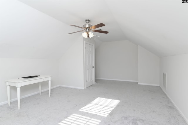 additional living space featuring carpet floors, visible vents, lofted ceiling, baseboards, and a ceiling fan