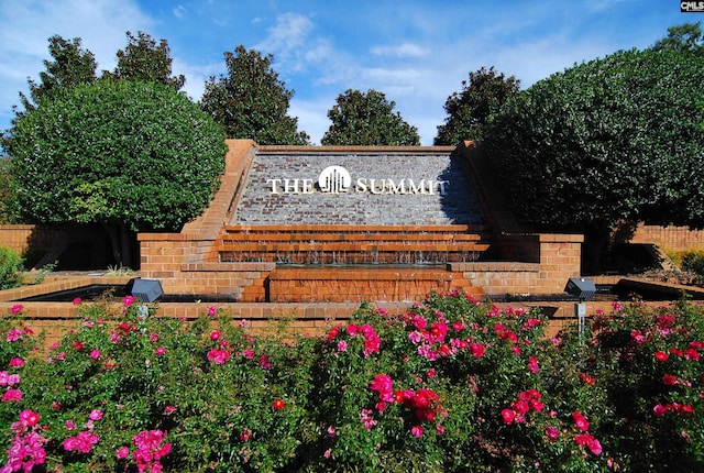 community sign featuring fence