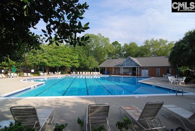 pool featuring a patio area and fence