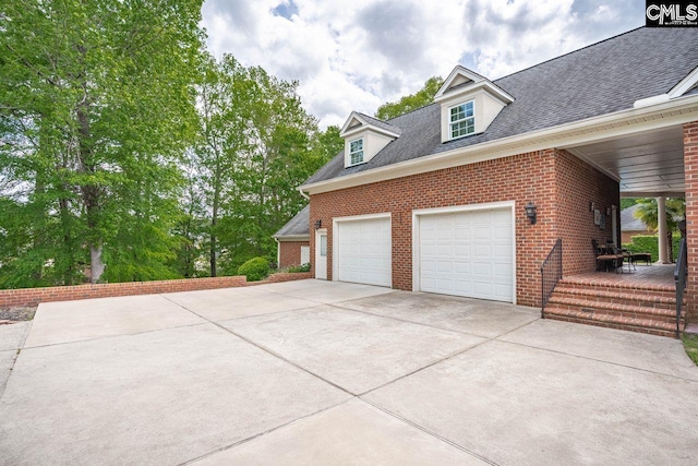 119 Ashley Trace Dr, Lexington, SC 29072 - view of property exterior featuring brick siding, driveway, a shingled roof, and a garage