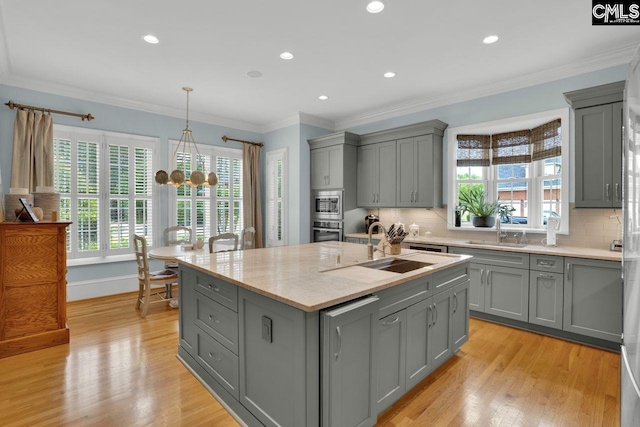 119 Ashley Trace Dr, Lexington, SC 29072 - kitchen with a notable chandelier, appliances with stainless steel finishes, a sink, a kitchen island with sink, and gray cabinetry