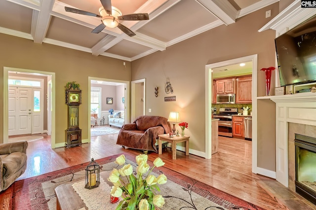 living area featuring a fireplace, coffered ceiling, beam ceiling, and light wood-type flooring