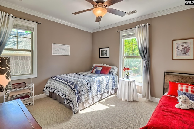 bedroom featuring visible vents, crown molding, baseboards, a ceiling fan, and carpet
