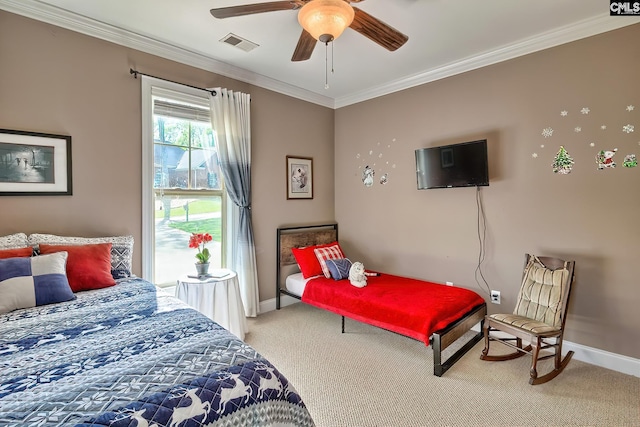 carpeted bedroom featuring baseboards, ornamental molding, a ceiling fan, and visible vents