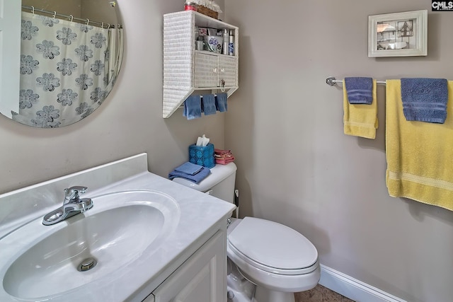 bathroom featuring vanity, toilet, and a shower with shower curtain