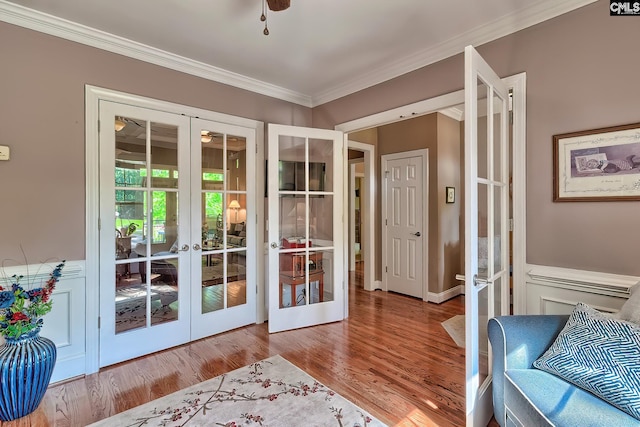 entryway with ornamental molding, french doors, and wood finished floors