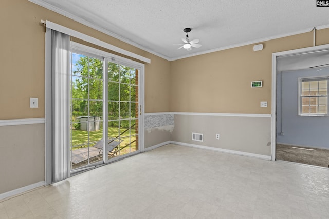 unfurnished room with ceiling fan, a textured ceiling, visible vents, tile patterned floors, and ornamental molding
