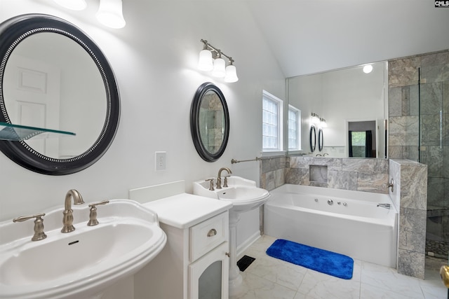 bathroom with marble finish floor, lofted ceiling, two sinks, tiled shower, and a garden tub