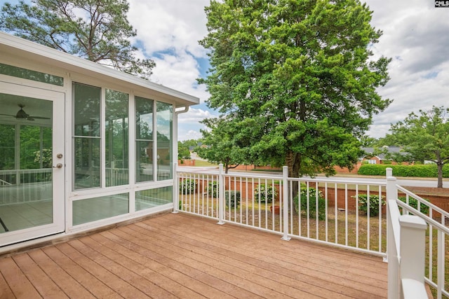 wooden deck with a sunroom