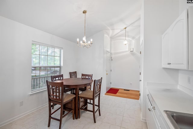 dining room featuring baseboards, marble finish floor, and a chandelier