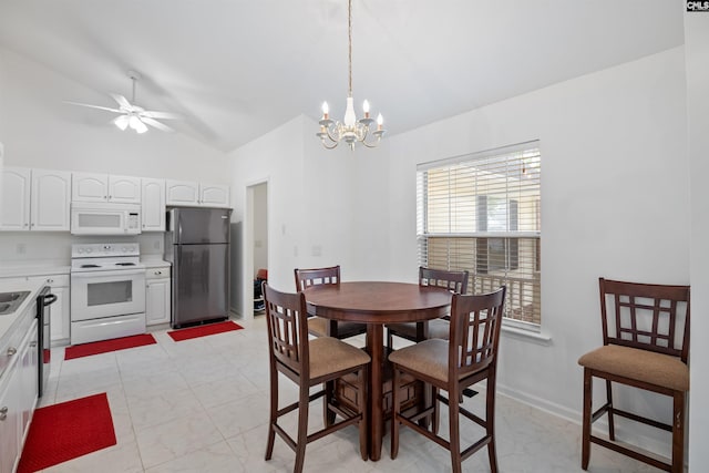 dining room with lofted ceiling and ceiling fan with notable chandelier