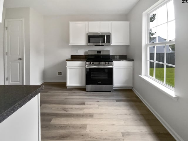 6 Sawdust Ct, Columbia, SC 29209 - kitchen featuring white cabinets, dark countertops, appliances with stainless steel finishes, and light wood-style flooring