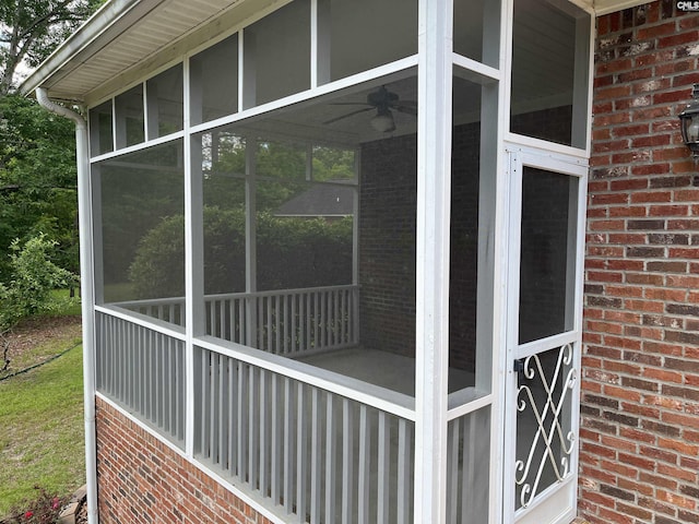 view of side of property with a sunroom and brick siding