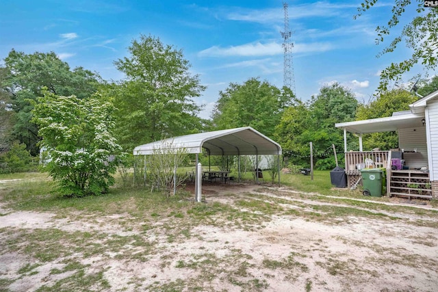 view of yard with a detached carport and driveway