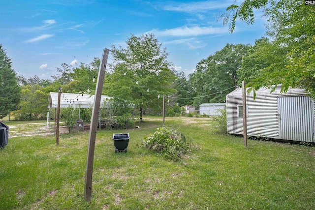 view of yard with a storage unit and an outbuilding