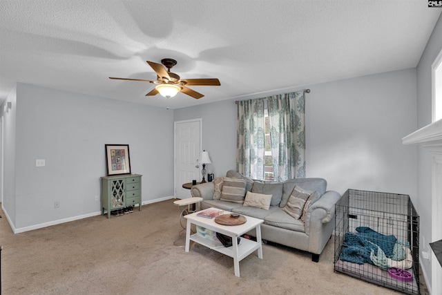 carpeted living area featuring baseboards, ceiling fan, and a textured ceiling