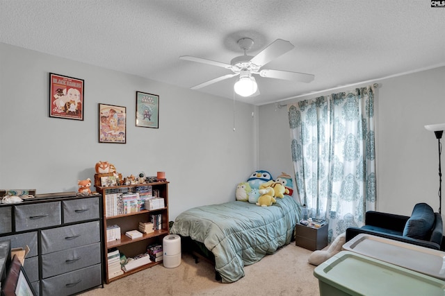 bedroom featuring a textured ceiling, carpet, and a ceiling fan