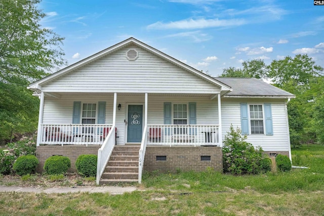 bungalow-style home featuring a porch, crawl space, and a shingled roof