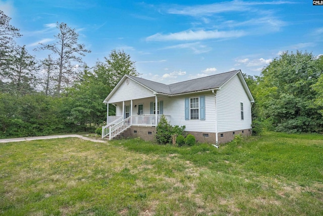 view of front facade with covered porch, crawl space, and a front yard