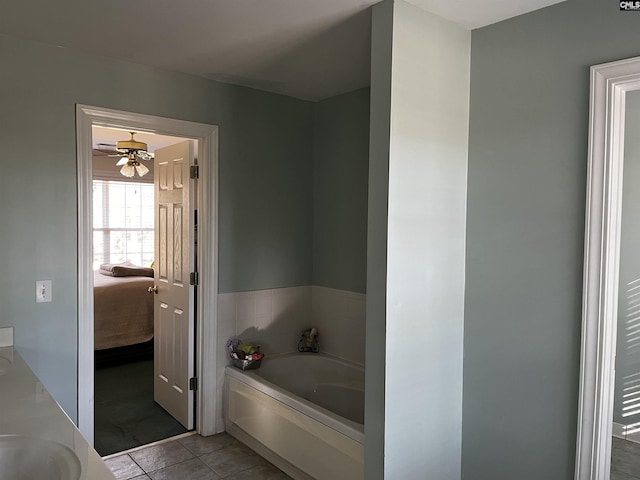 bathroom featuring connected bathroom, a sink, tile patterned flooring, a ceiling fan, and a bath