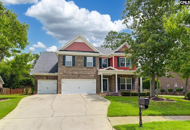 craftsman-style home featuring fence, a front lawn, brick siding, a garage, and driveway