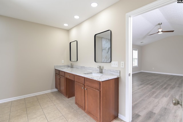 full bath featuring a sink, baseboards, a ceiling fan, and vaulted ceiling