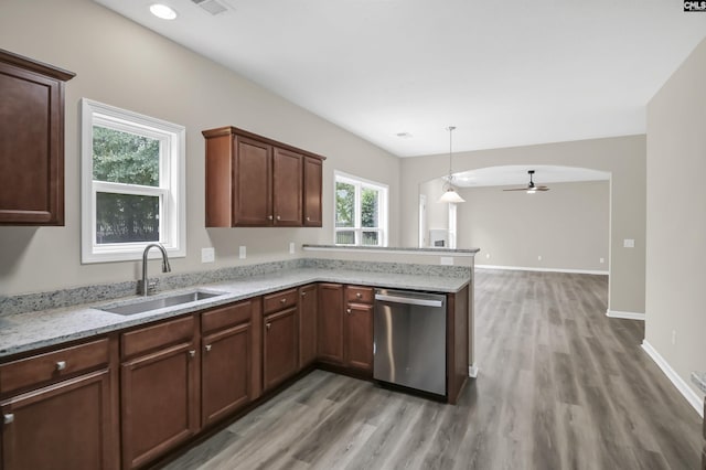 kitchen featuring a peninsula, ceiling fan, a sink, light wood finished floors, and dishwasher