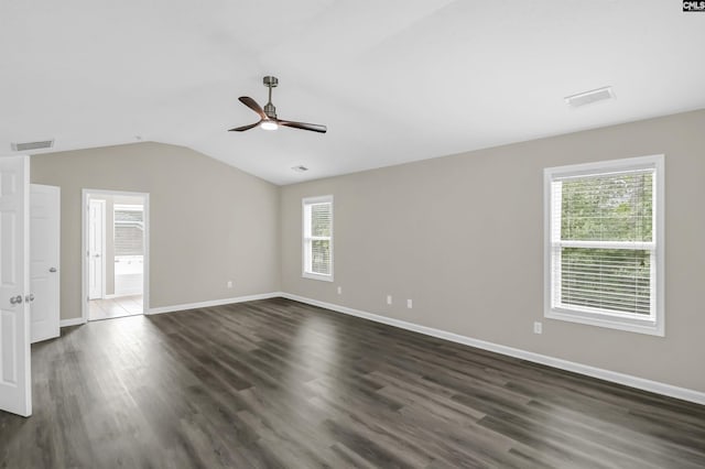 spare room with a ceiling fan, visible vents, dark wood finished floors, baseboards, and lofted ceiling
