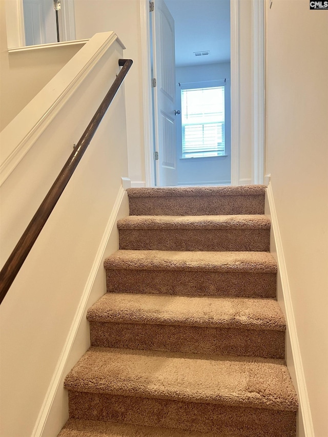 staircase featuring visible vents