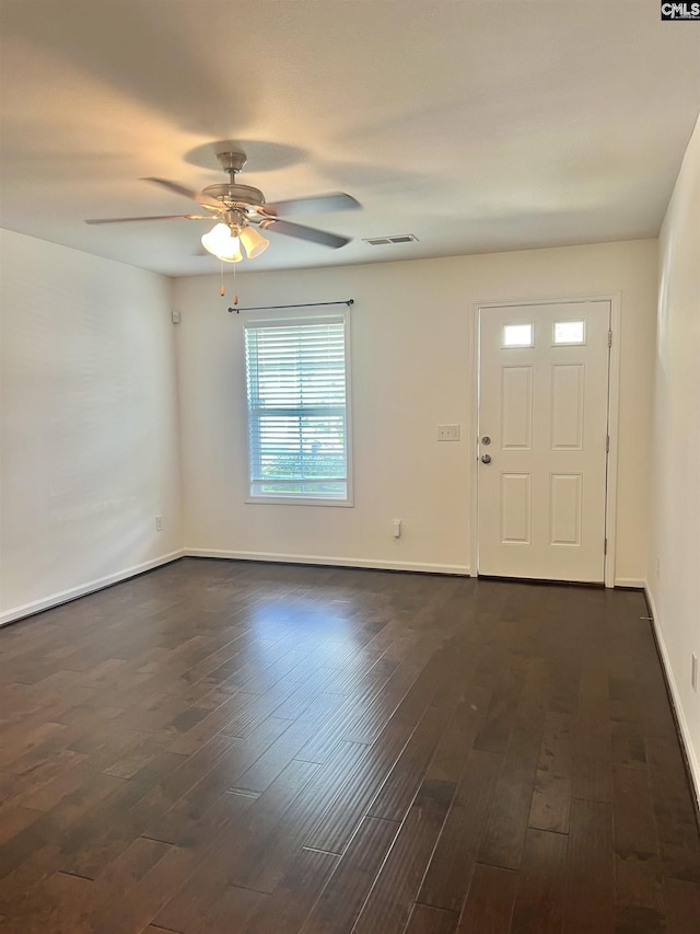 foyer featuring dark wood-style flooring, a ceiling fan, baseboards, and visible vents