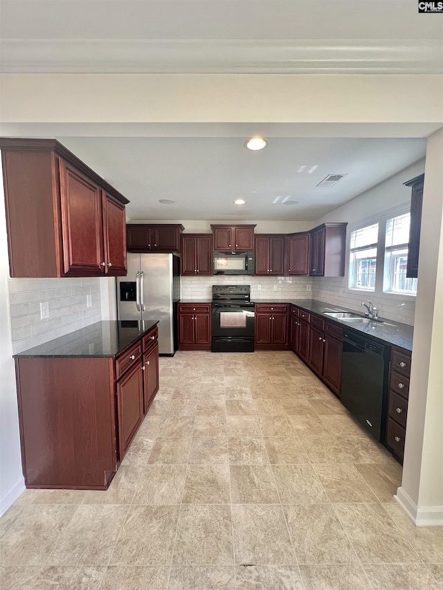 kitchen with visible vents, backsplash, and black appliances