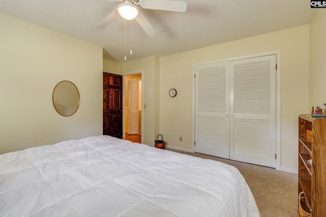 bedroom with baseboards, ceiling fan, carpet, and a closet