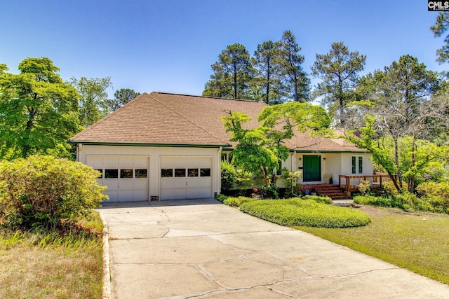 ranch-style home featuring board and batten siding, driveway, a shingled roof, and a garage