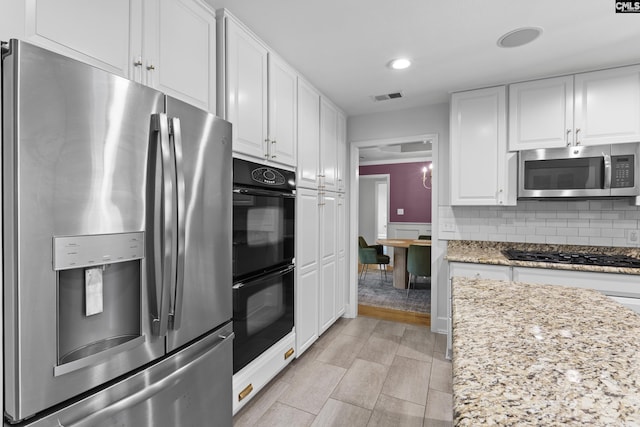 5904 Lakeshore Dr, Columbia, SC 29206 - kitchen with backsplash, visible vents, white cabinets, black appliances, and recessed lighting