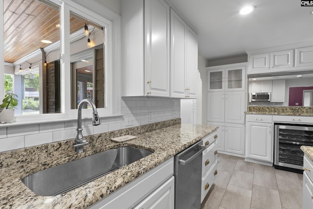 5904 Lakeshore Dr, Columbia, SC 29206 - kitchen with stainless steel dishwasher, white cabinets, a sink, and wine cooler