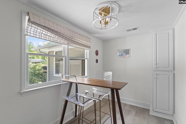 5904 Lakeshore Dr, Columbia, SC 29206 - dining area with baseboards, a notable chandelier, and visible vents