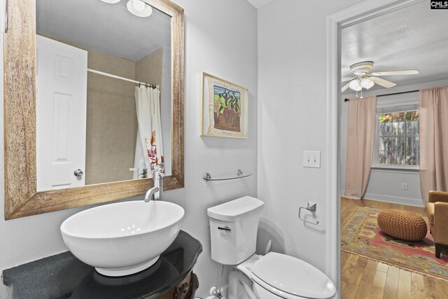 5904 Lakeshore Dr, Columbia, SC 29206 - bathroom with a ceiling fan, wood finished floors, curtained shower, toilet, and a sink