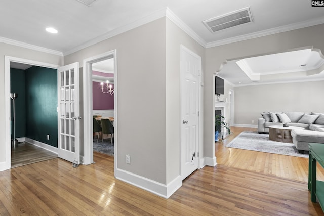 5904 Lakeshore Dr, Columbia, SC 29206 - living room featuring crown molding, wood-type flooring, baseboards, a fireplace with flush hearth, and visible vents