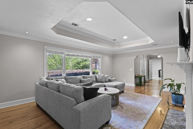 5904 Lakeshore Dr, Columbia, SC 29206 - living room with visible vents, crown molding, wood finished floors, baseboards, and a raised ceiling