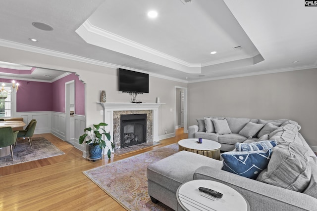 5904 Lakeshore Dr, Columbia, SC 29206 - living room featuring crown molding, a fireplace, a tray ceiling, and light wood-style flooring