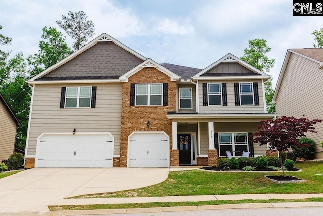 craftsman-style home featuring a garage, a front lawn, covered porch, brick siding, and driveway